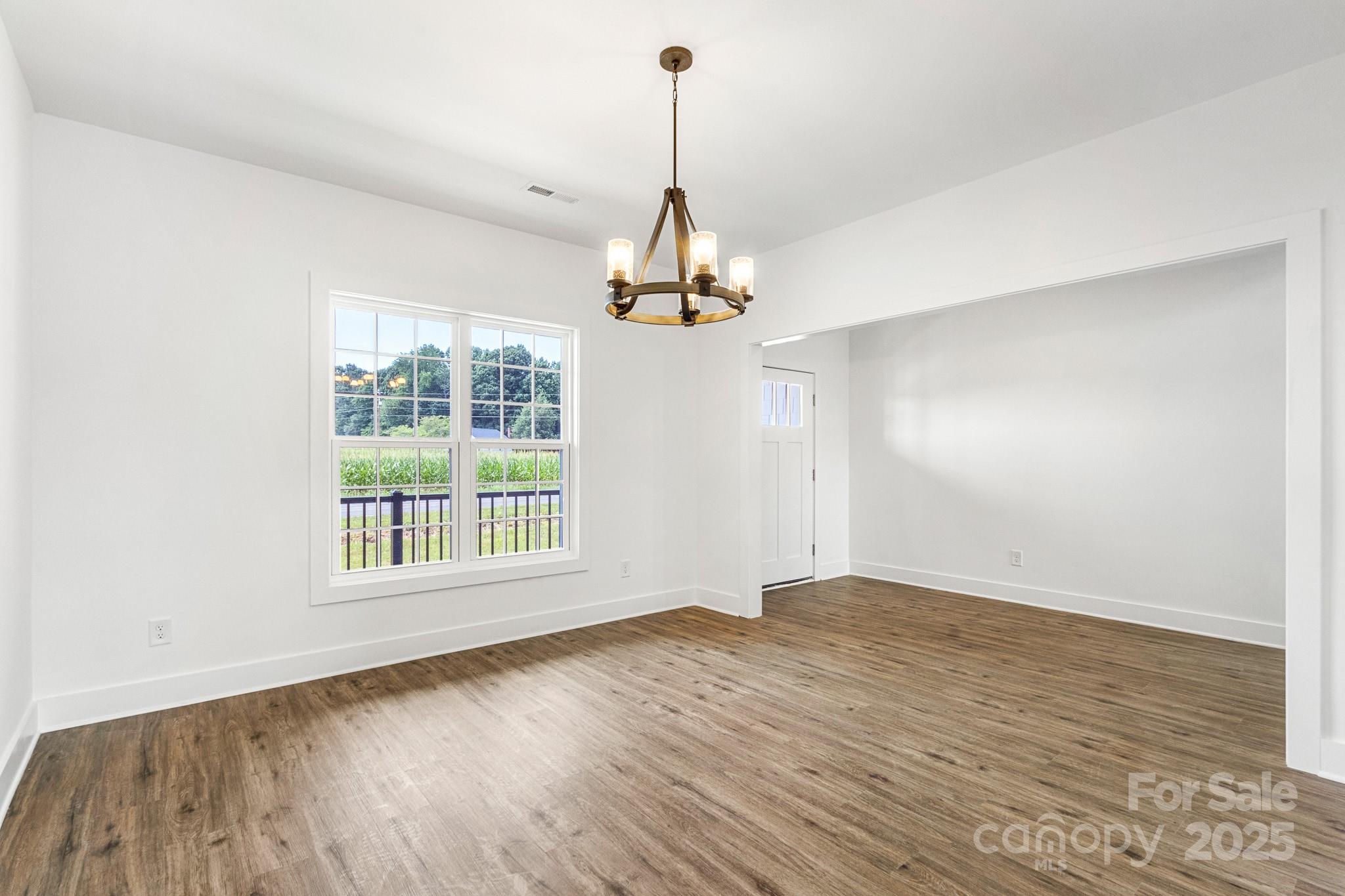 2025 Parks Road Salisbury, NC 28147 - Photo 5 of 47 a view of an empty room with wooden floor and a window