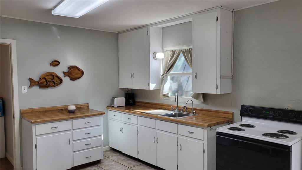 25208 Old Ferry Road Spicewood, TX 78669 - Photo 14 of 18 a kitchen with cabinets appliances and a window
