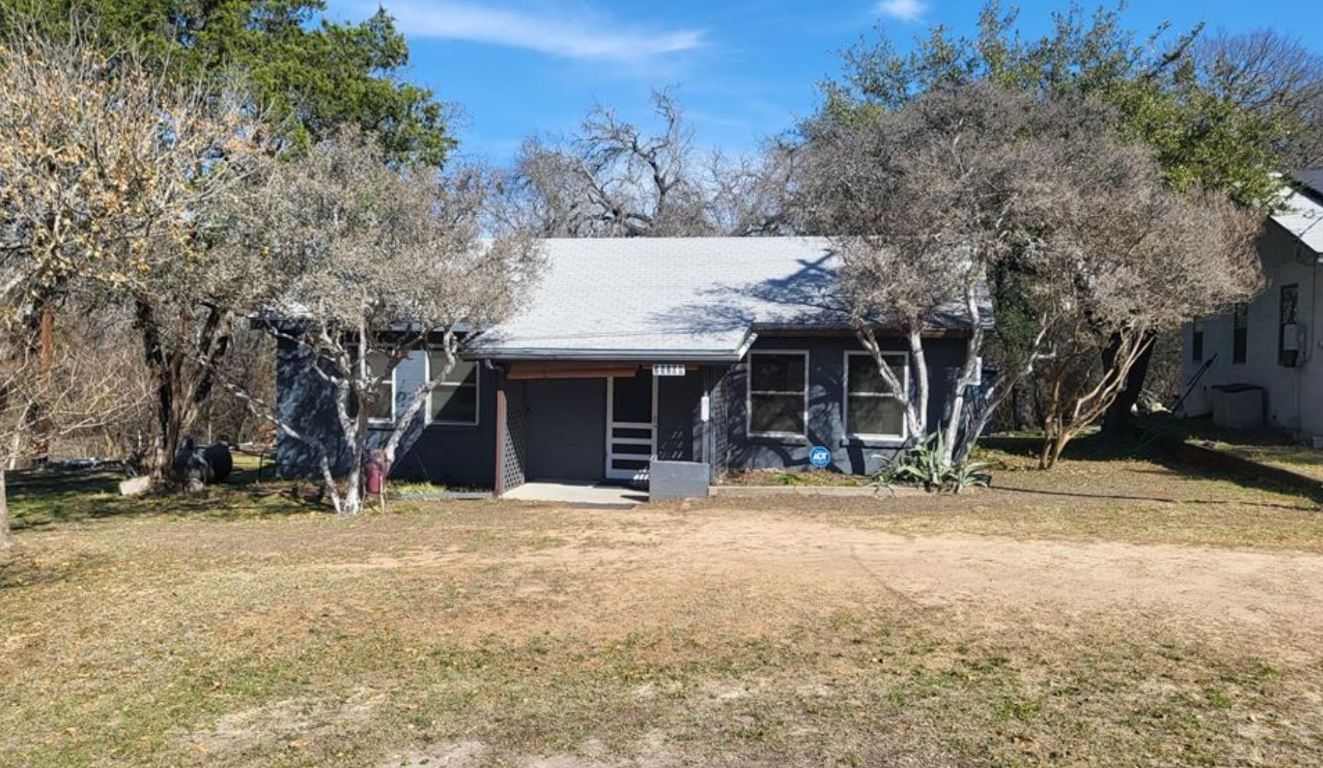 25208 Old Ferry Road Spicewood, TX 78669 - Photo 2 of 18 a view of a house with a yard covered with snow