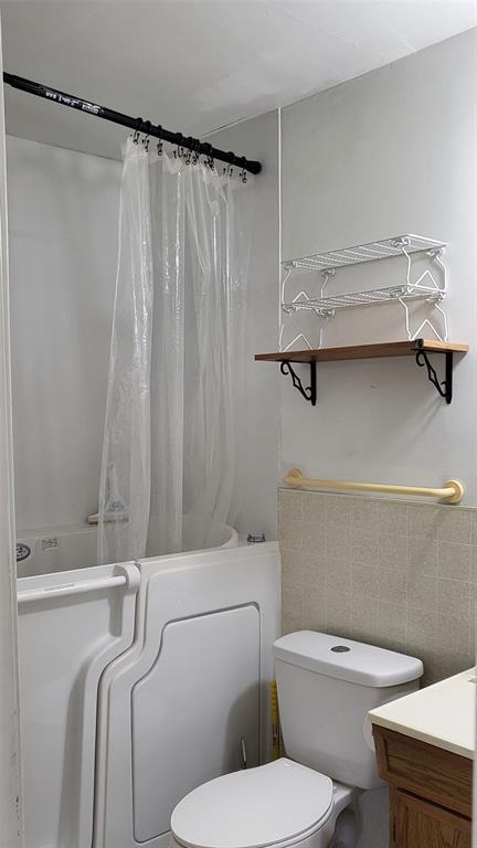 25208 Old Ferry Road Spicewood, TX 78669 - Photo 7 of 18 a white toilet sitting next to a bath tub