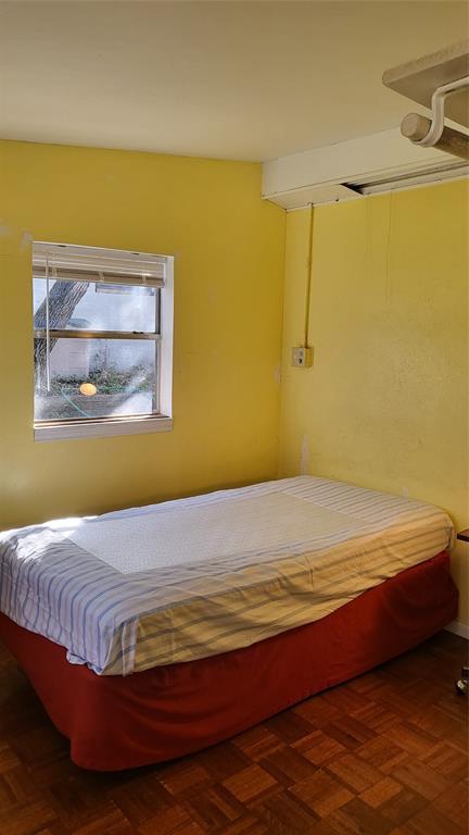 25208 Old Ferry Road Spicewood, TX 78669 - Photo 9 of 18 a bedroom with a bed and painting on the wall