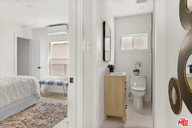 a bathroom with a toilet a sink and a mirror