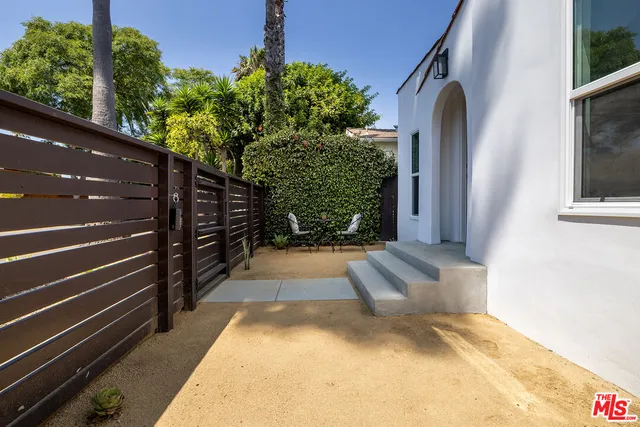 a view of backyard with wooden fence