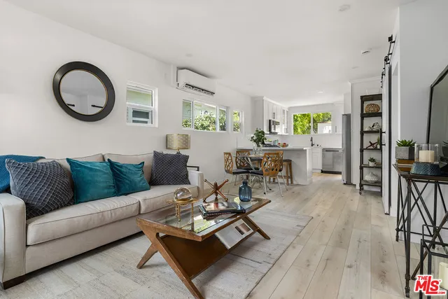 a living room with furniture a rug floor and a window