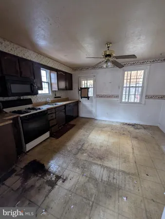 a view of a kitchen with a sink and cabinets