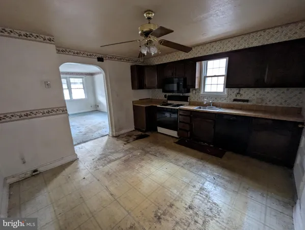 a large kitchen with stainless steel appliances granite countertop a sink dishwasher stove and cabinets