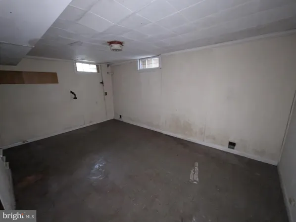 an empty room with a empty space and windows