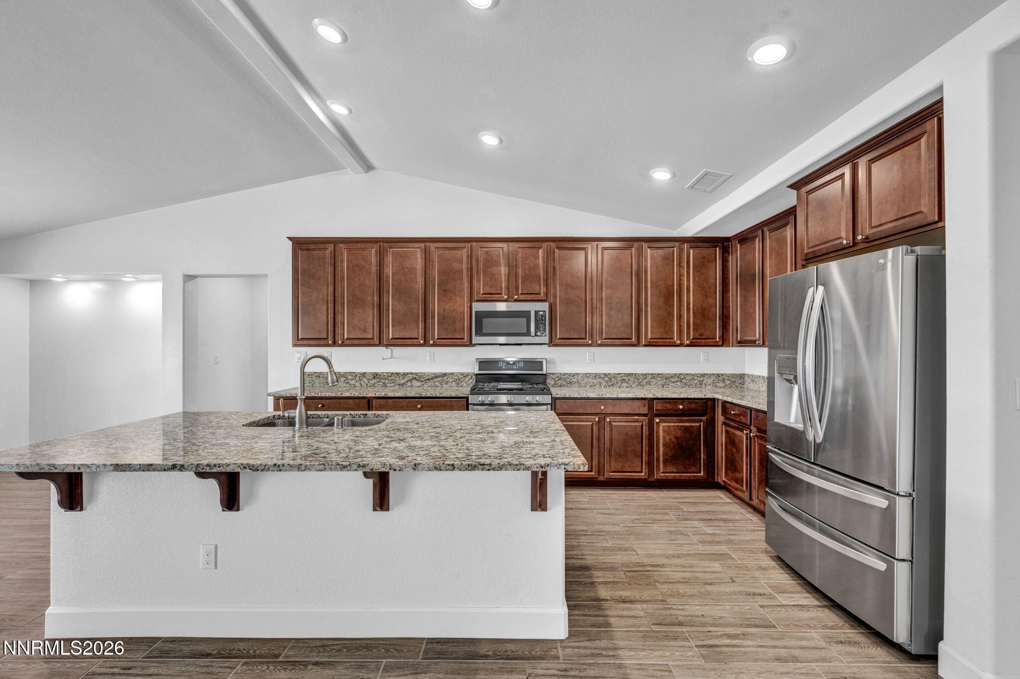 7181 Saddlehorn Road Carson City, NV 89701 - Photo 22 of 62 a kitchen with stainless steel appliances granite countertop a refrigerator sink and cabinets