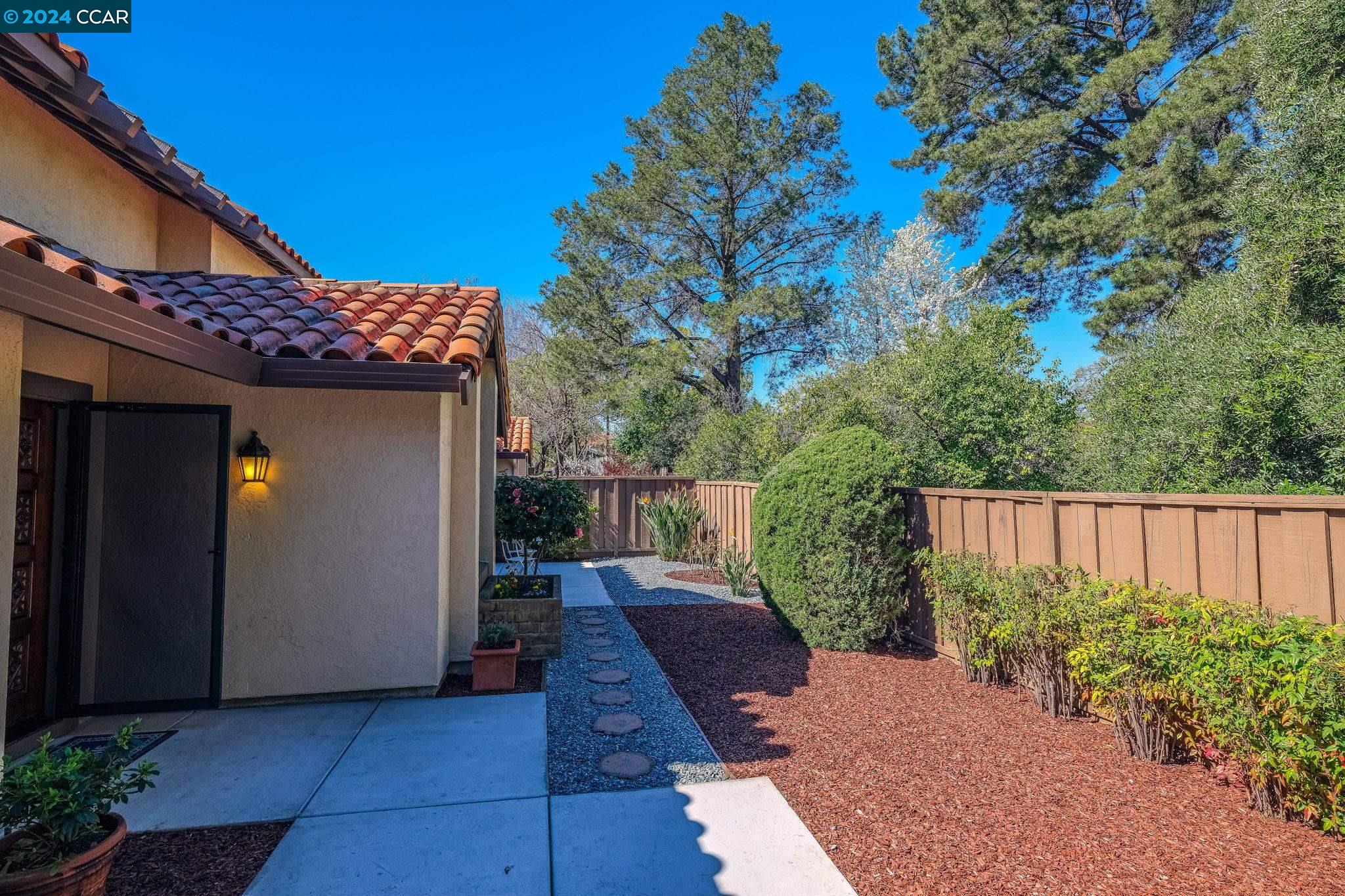 646 Preakness Drive Walnut Creek, CA 94597 - Photo 2 of 26 a view of a pathway of a house with wooden fence