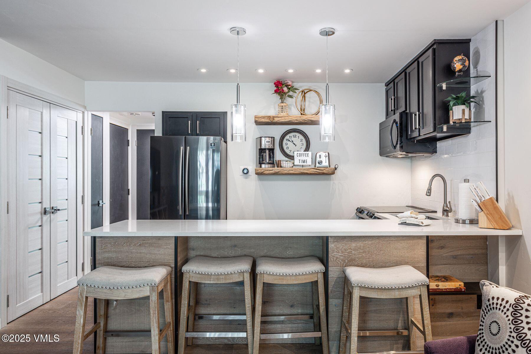 4630 Vail Racquet Club Drive, Unit 15 Vail, CO 81657 - Photo 3 of 20 a kitchen with a sink cabinets and stainless steel appliances