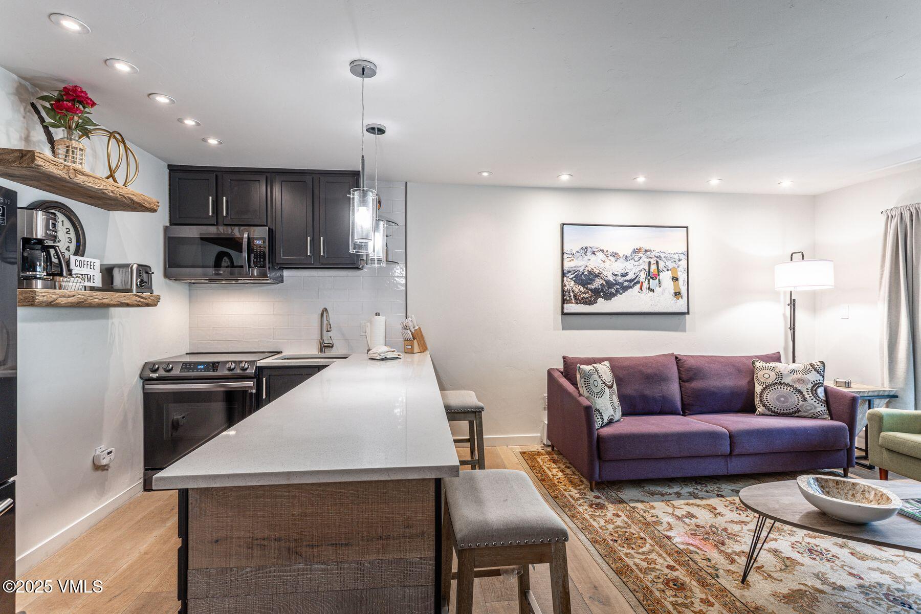 4630 Vail Racquet Club Drive, Unit 15 Vail, CO 81657 - Photo 4 of 20 a kitchen with stainless steel appliances granite countertop a stove a sink a refrigerator and a refrigerator