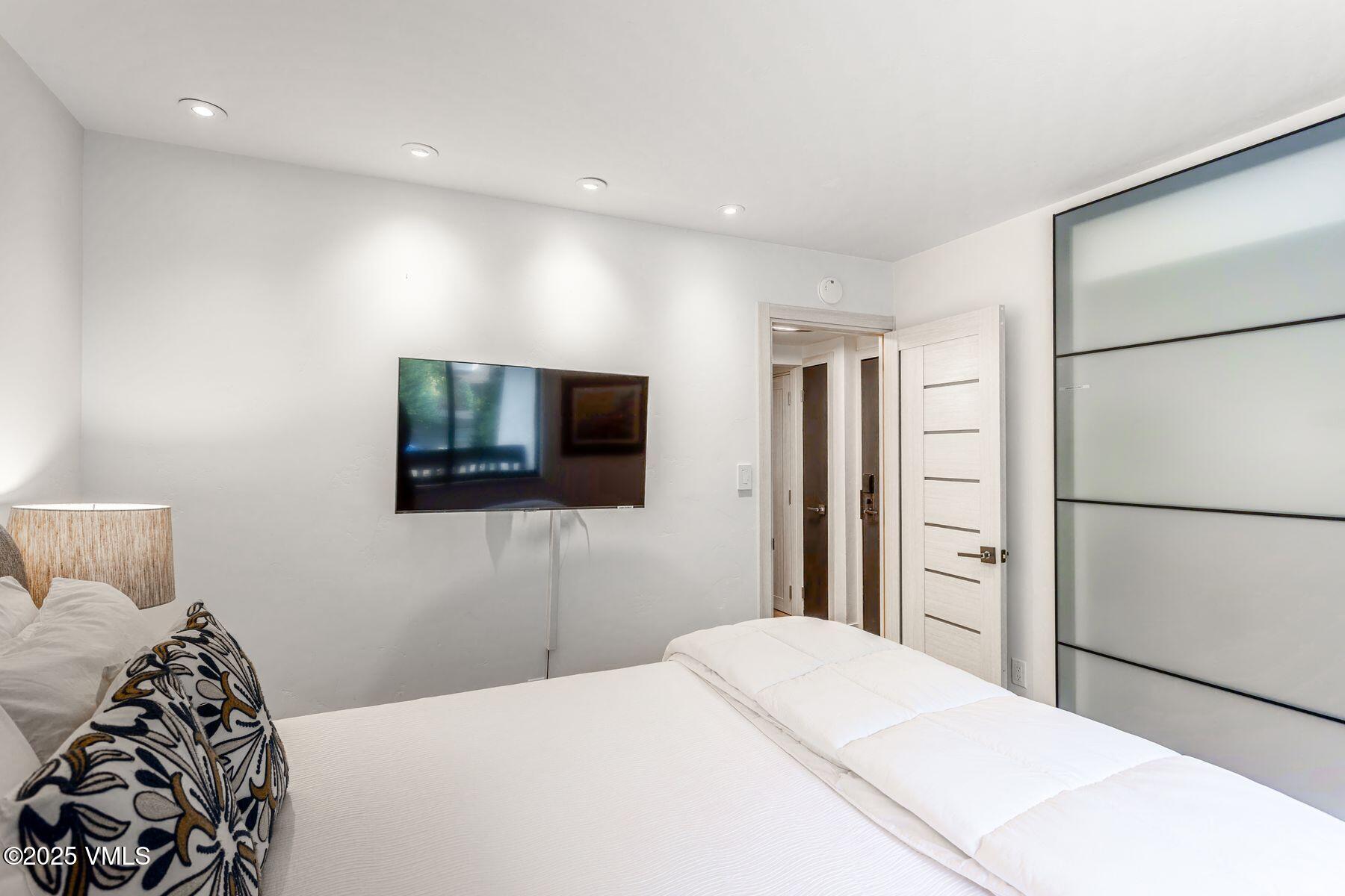 4630 Vail Racquet Club Drive, Unit 15 Vail, CO 81657 - Photo 6 of 20 a bedroom with a bed and a flat screen tv