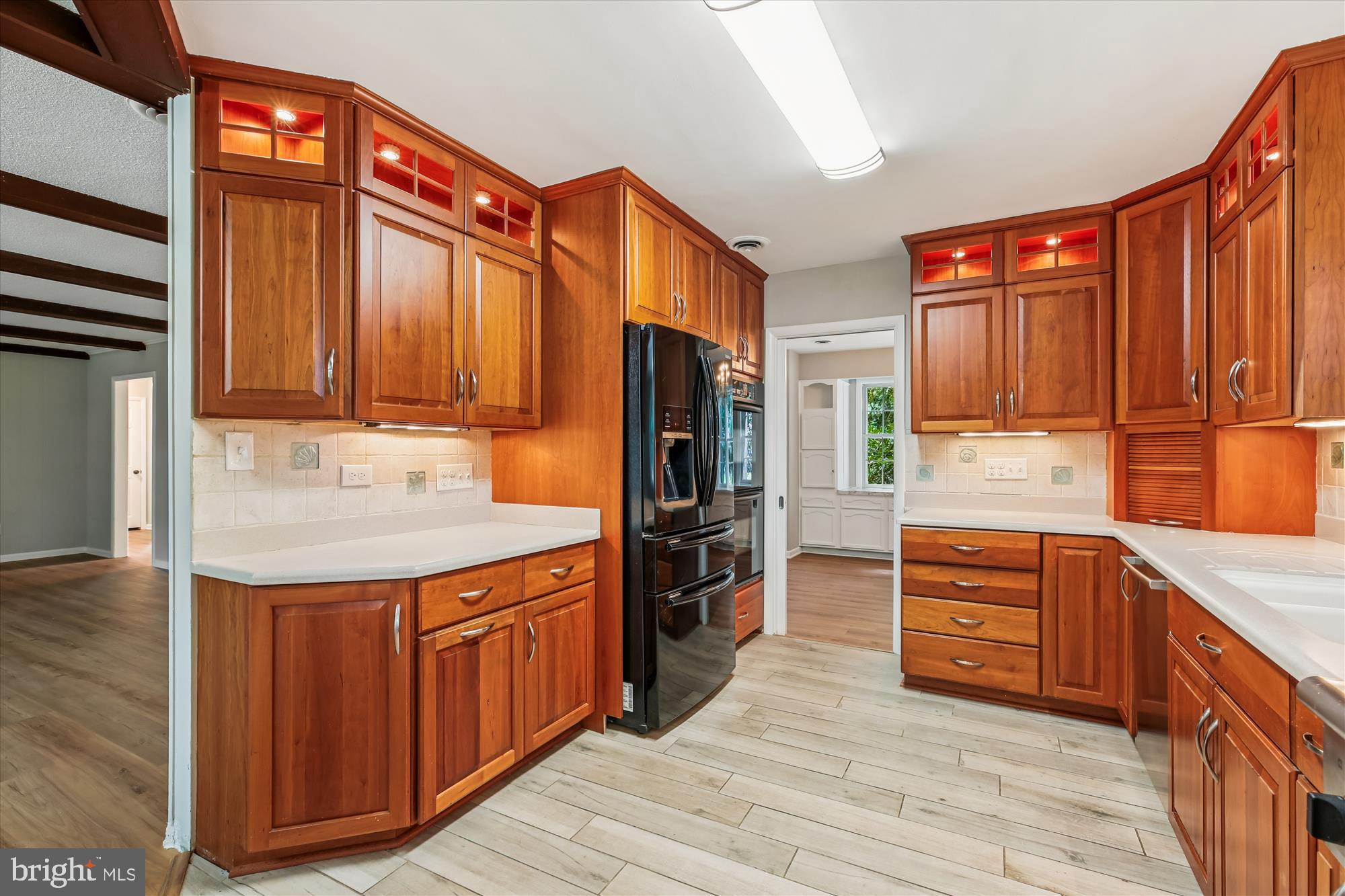 11803 Eden Road Silver Spring, MD 20904 - Photo 12 of 45 a kitchen with stainless steel appliances granite countertop a refrigerator and wooden cabinets