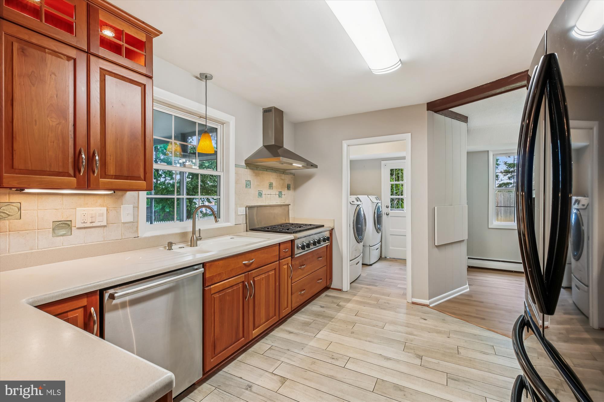 11803 Eden Road Silver Spring, MD 20904 - Photo 14 of 45 a kitchen with stainless steel appliances granite countertop a refrigerator a sink dishwasher a stove and white countertops with wooden floor
