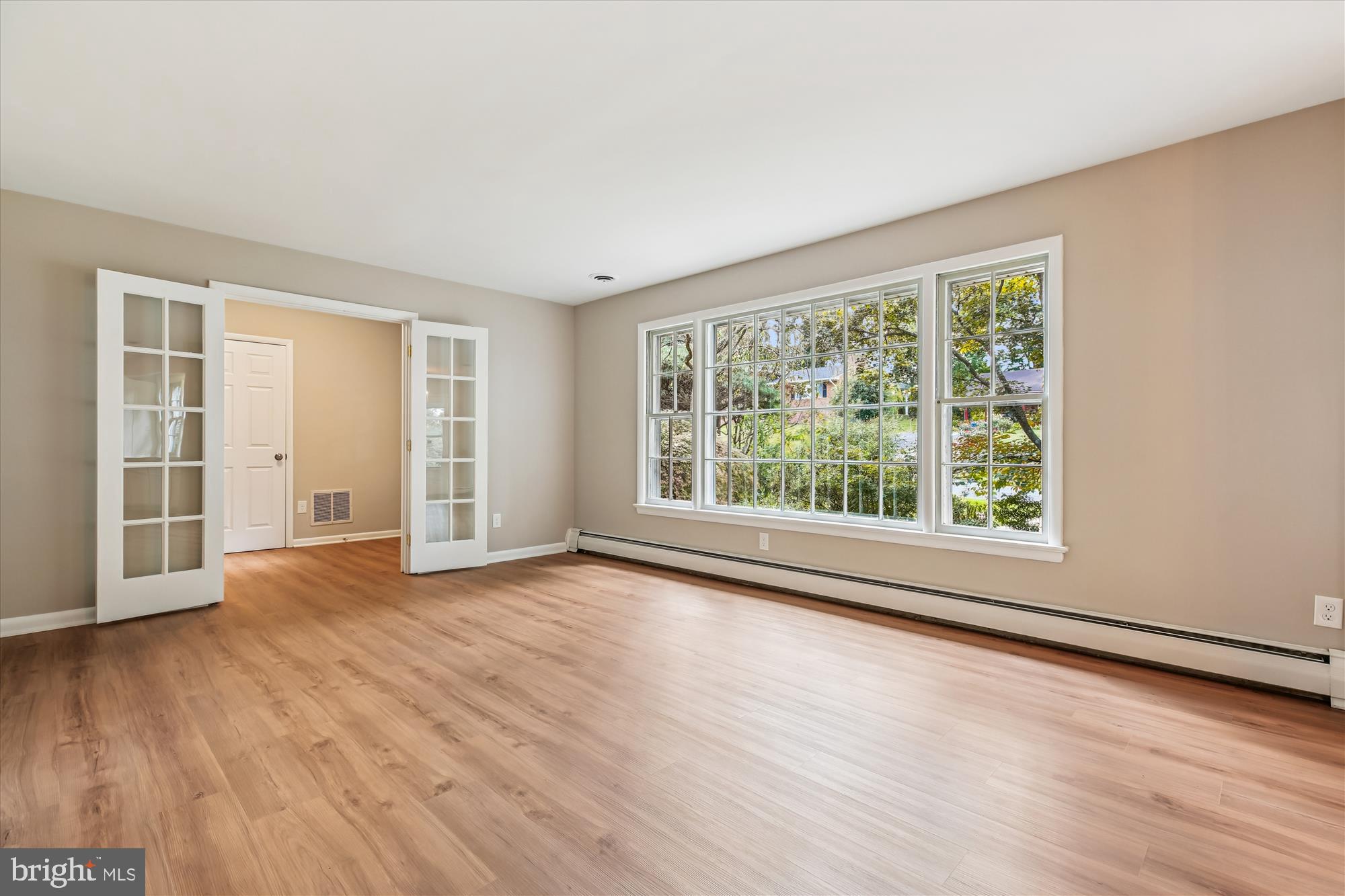 11803 Eden Road Silver Spring, MD 20904 - Photo 17 of 45 a view of an empty room with wooden floor and a window