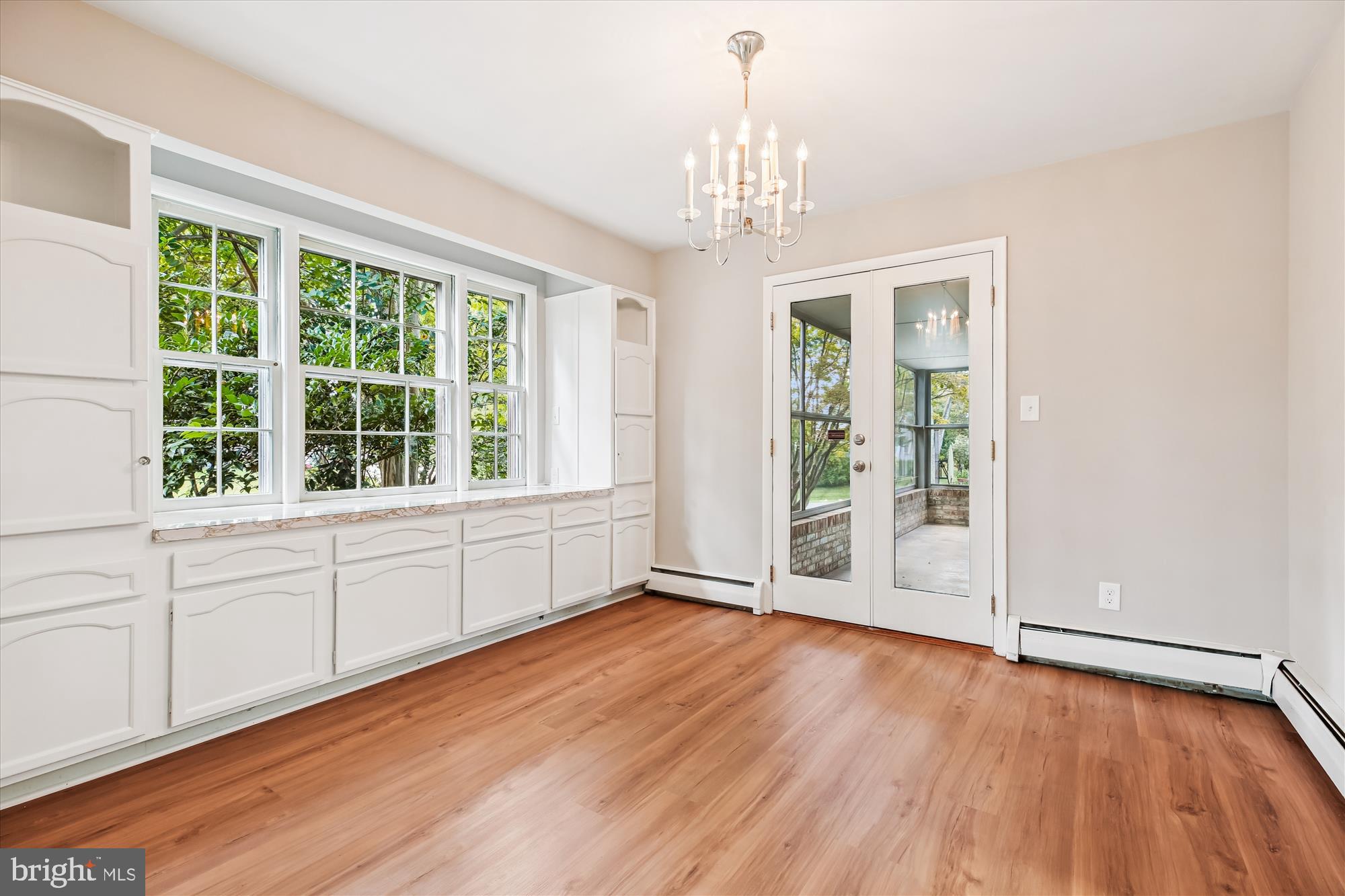 11803 Eden Road Silver Spring, MD 20904 - Photo 19 of 45 a view of an empty room with a window and wooden floor