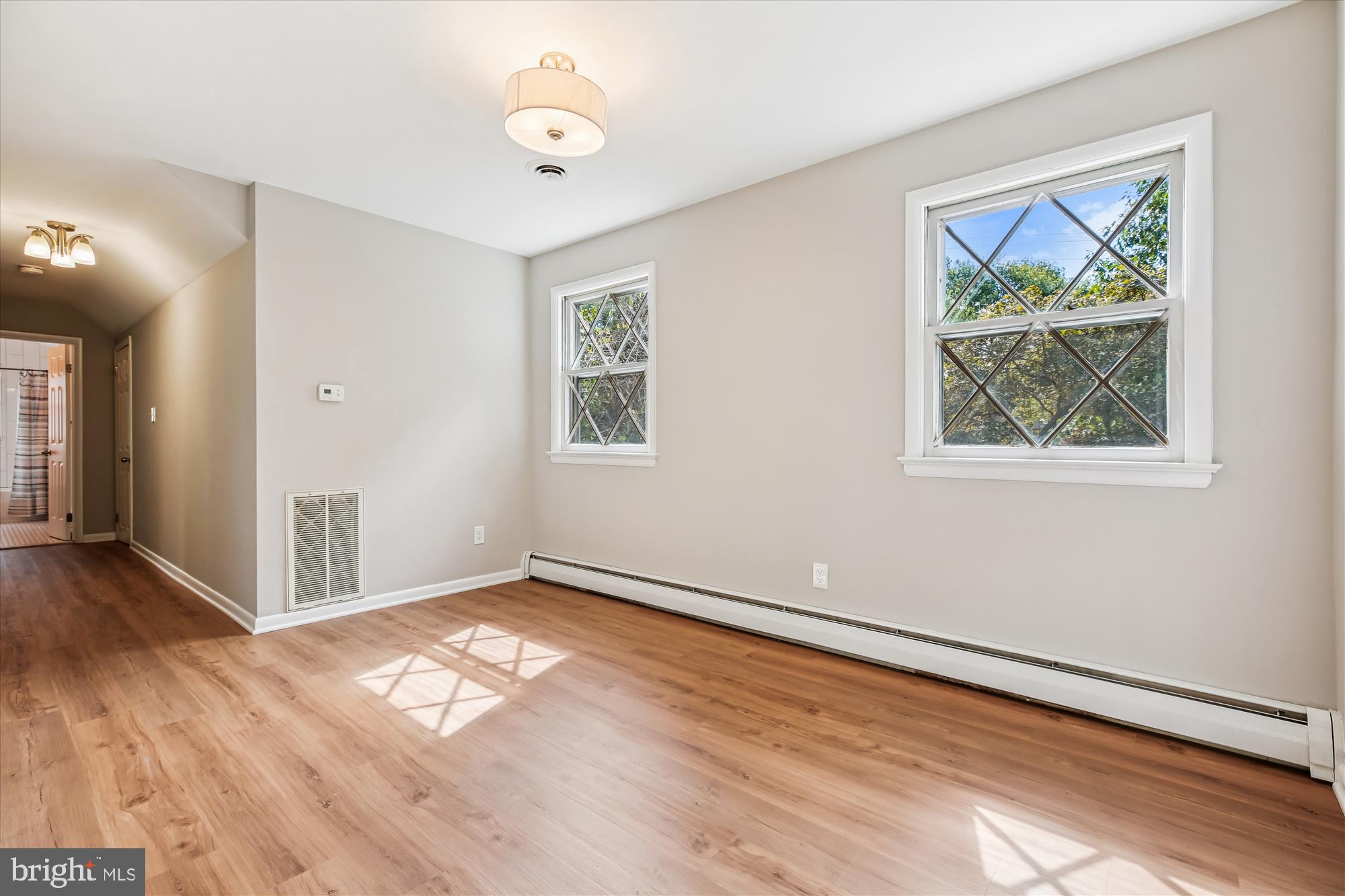 11803 Eden Road Silver Spring, MD 20904 - Photo 41 of 45 an empty room with wooden floor and window