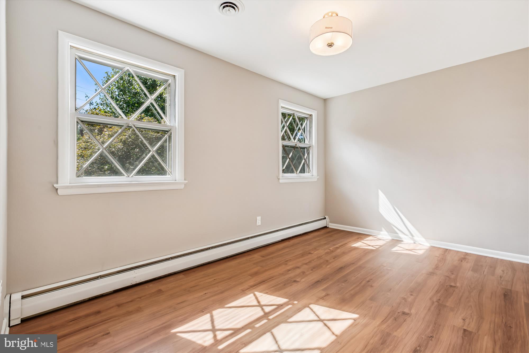 11803 Eden Road Silver Spring, MD 20904 - Photo 42 of 45 an empty room with wooden floor and windows