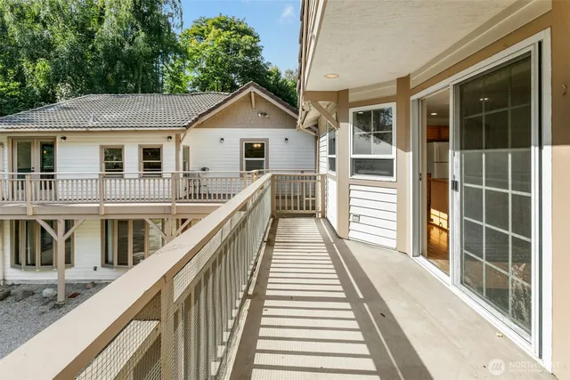 a view of a house with wooden stairs and a balcony