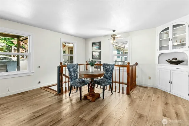 a view of a dining room with furniture and wooden floor
