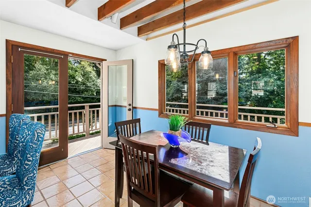 a view of a dining room with furniture large windows and wooden floor
