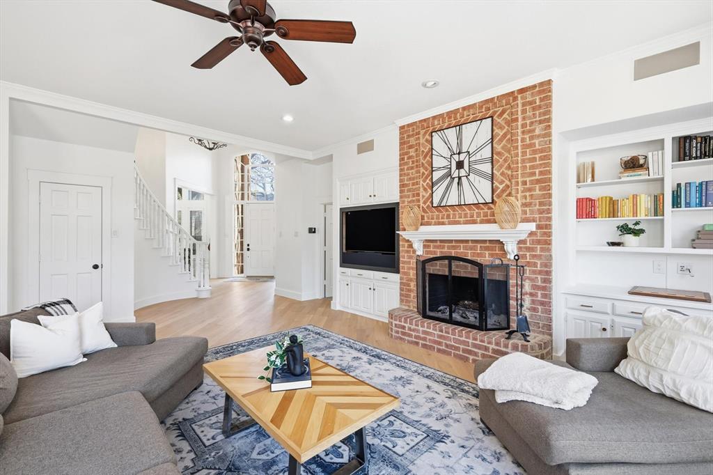 117 Sand Point Court Coppell, TX 75019 - Photo 11 of 40 a living room with furniture a window and a fireplace