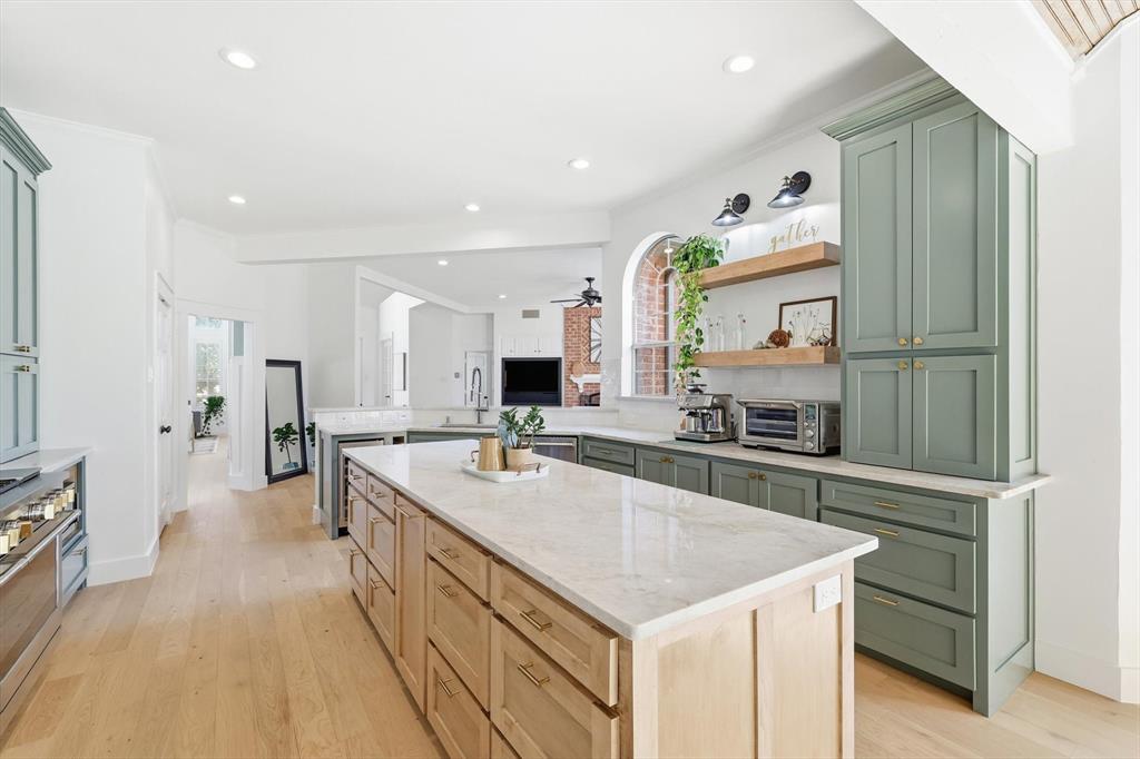 117 Sand Point Court Coppell, TX 75019 - Photo 15 of 40 a large kitchen with a large counter top appliances and cabinets