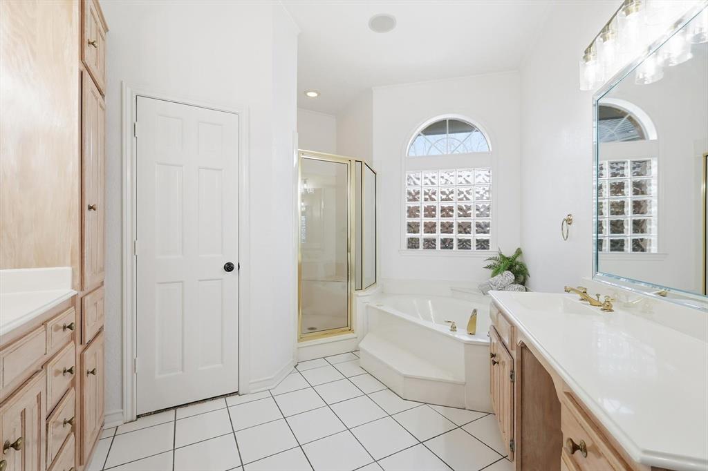 117 Sand Point Court Coppell, TX 75019 - Photo 19 of 40 a spacious bathroom with a bathtub sink and mirror