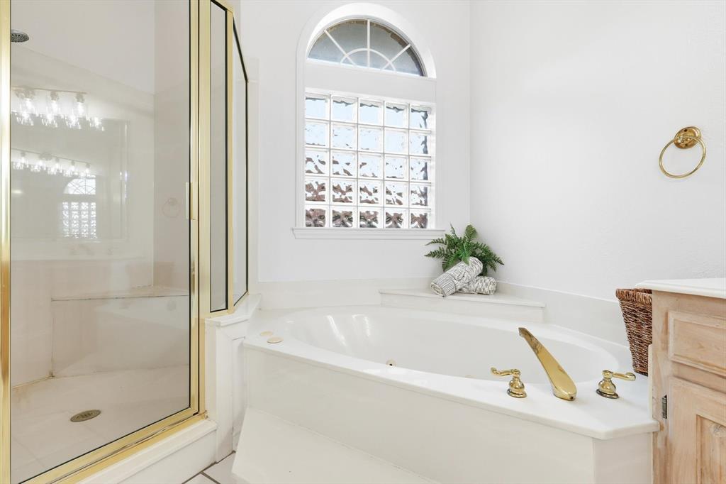117 Sand Point Court Coppell, TX 75019 - Photo 22 of 40 a white bath tub sitting next to a shower