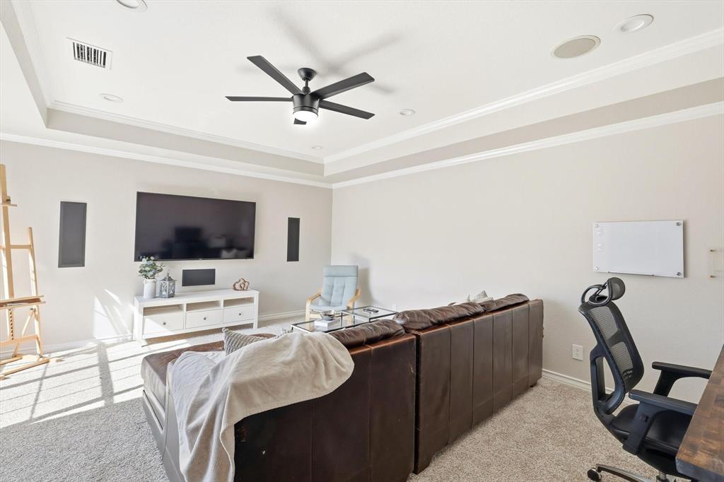 117 Sand Point Court Coppell, TX 75019 - Photo 25 of 40 a living room with furniture and a flat screen tv