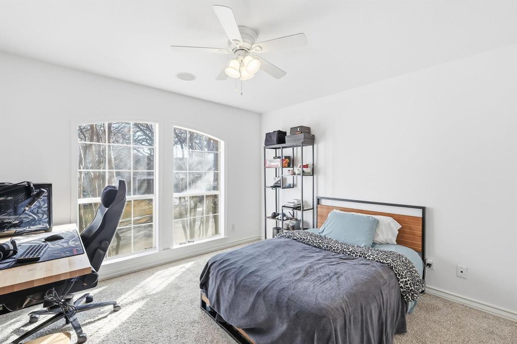 117 Sand Point Court Coppell, TX 75019 - Photo 30 of 40 a bedroom with a large bed and a window