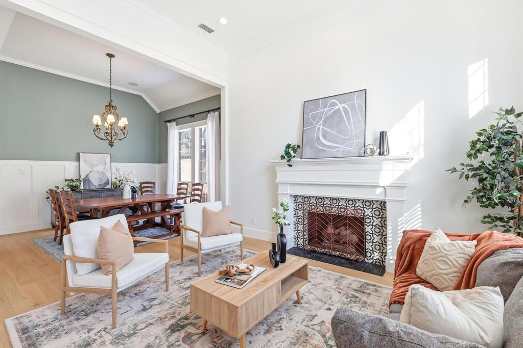 117 Sand Point Court Coppell, TX 75019 - Photo 5 of 40 a living room with furniture a chandelier and a fireplace