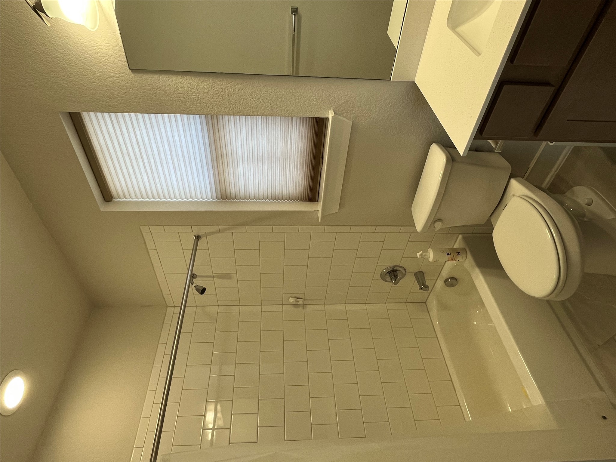 4420 Kings Cross Road Pflugerville, TX 78660 - Photo 8 of 13 A well-appointed bathroom features a combined shower and tub, sleek vanity, and privacy window.
