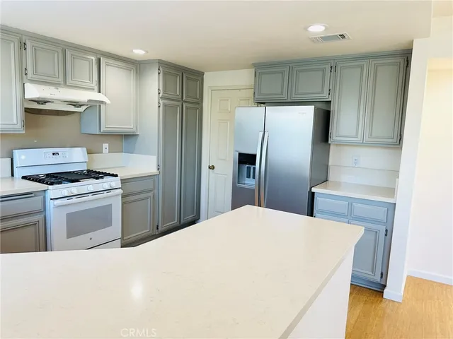 a kitchen with stainless steel appliances a refrigerator stove and sink