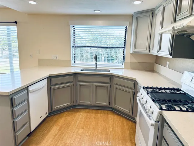 a kitchen with a sink a stove and cabinets