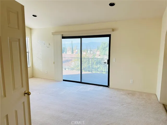 a view of an empty room with glass door