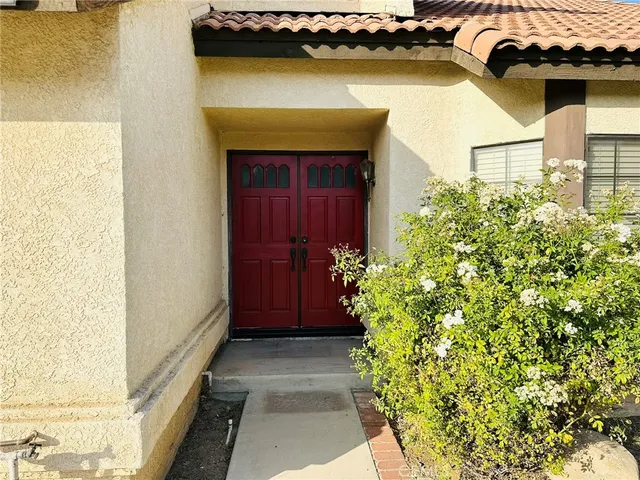 a view of a small house with potted plants
