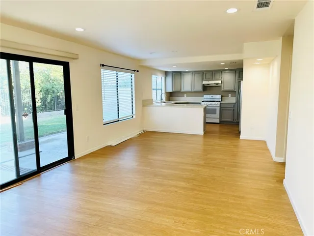 a view of kitchen and mountain view with wooden floor