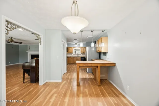 a view of a room with wooden floor and furniture