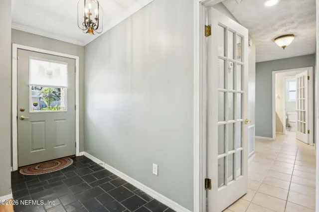 a view of a hallway with entryway door