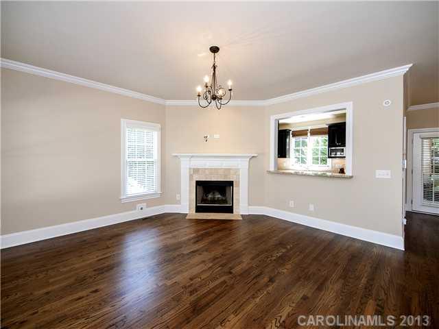 810 Millbrook Road Charlotte, NC 28211 - Photo 3 of 16 a view of a livingroom with wooden floor a fireplace and windows