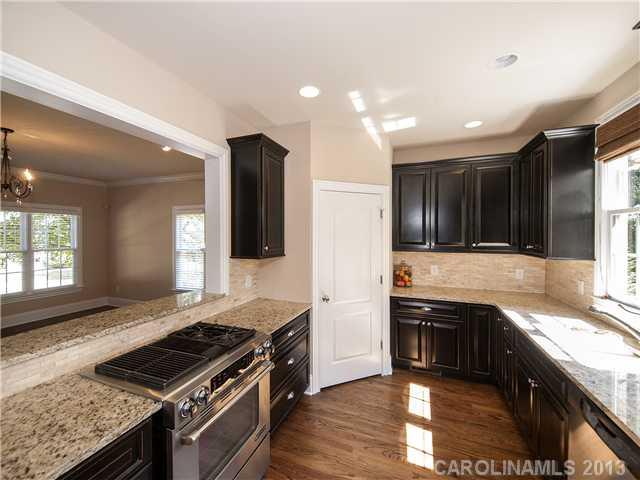 810 Millbrook Road Charlotte, NC 28211 - Photo 4 of 16 a kitchen with stainless steel appliances granite countertop a stove and a sink
