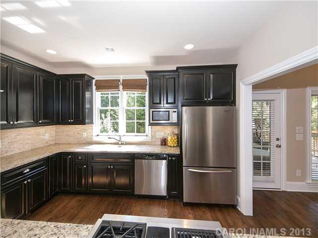 810 Millbrook Road Charlotte, NC 28211 - Photo 5 of 16 a kitchen with a sink a refrigerator and a stove top oven