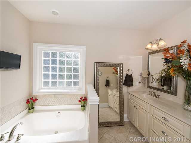 810 Millbrook Road Charlotte, NC 28211 - Photo 8 of 16 a bathroom with a tub sink and mirror