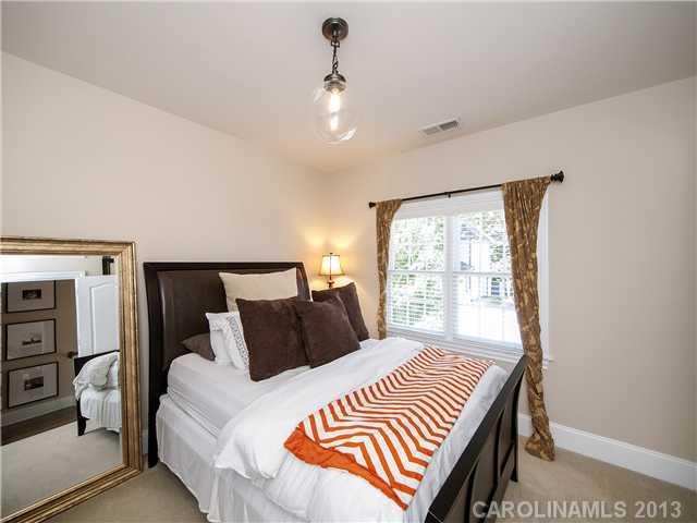 810 Millbrook Road Charlotte, NC 28211 - Photo 9 of 16 a bedroom with a bed and wooden floor