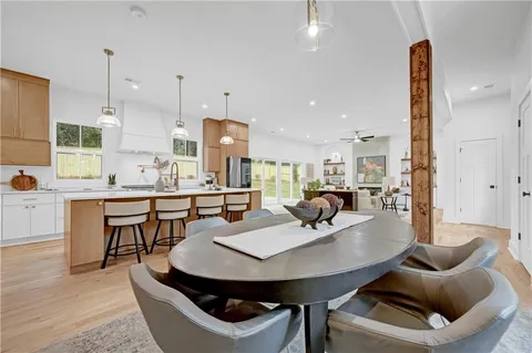 a view of a dining room with furniture and wooden floor