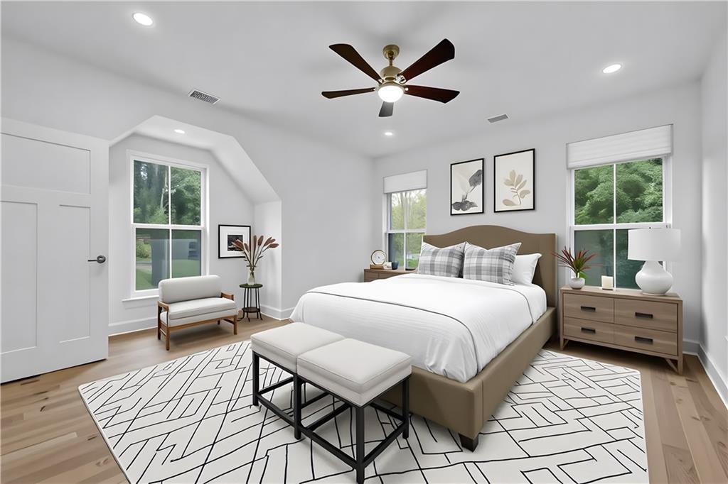 2893 Lavista Road Decatur, GA 30033 - Photo 23 of 37 a spacious bedroom with a bed a couch and a large window