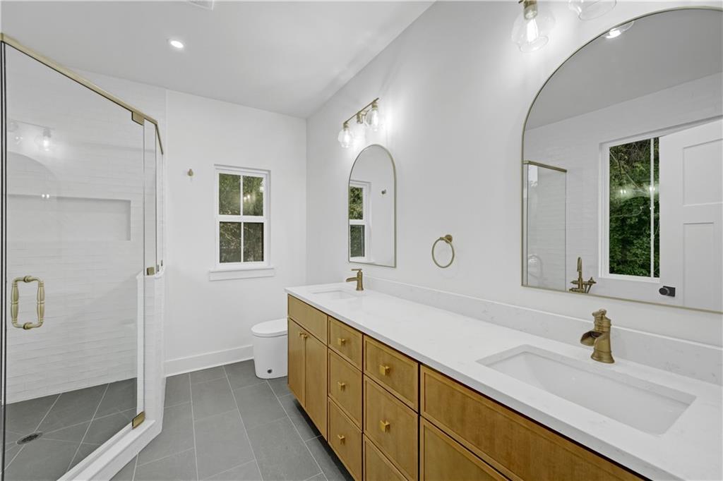 2893 Lavista Road Decatur, GA 30033 - Photo 24 of 37 a spacious bathroom with a double vanity sink mirror and shower