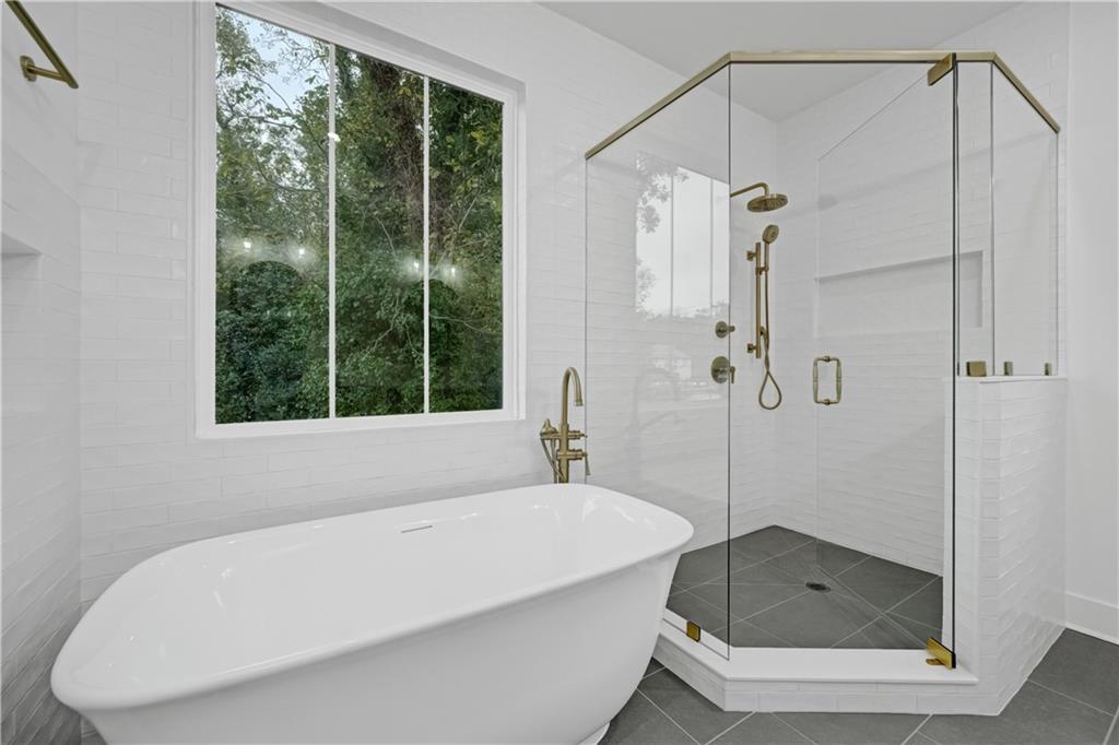 2893 Lavista Road Decatur, GA 30033 - Photo 25 of 37 a bathroom with a tub a window and a shower