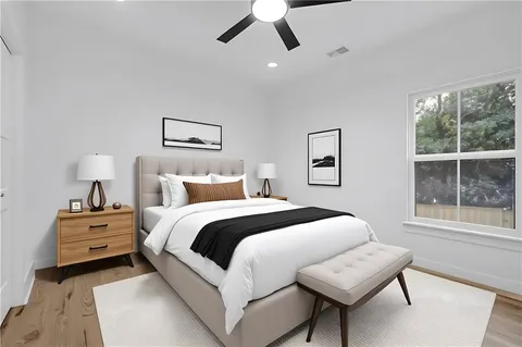 a bedroom with a bed and a large window